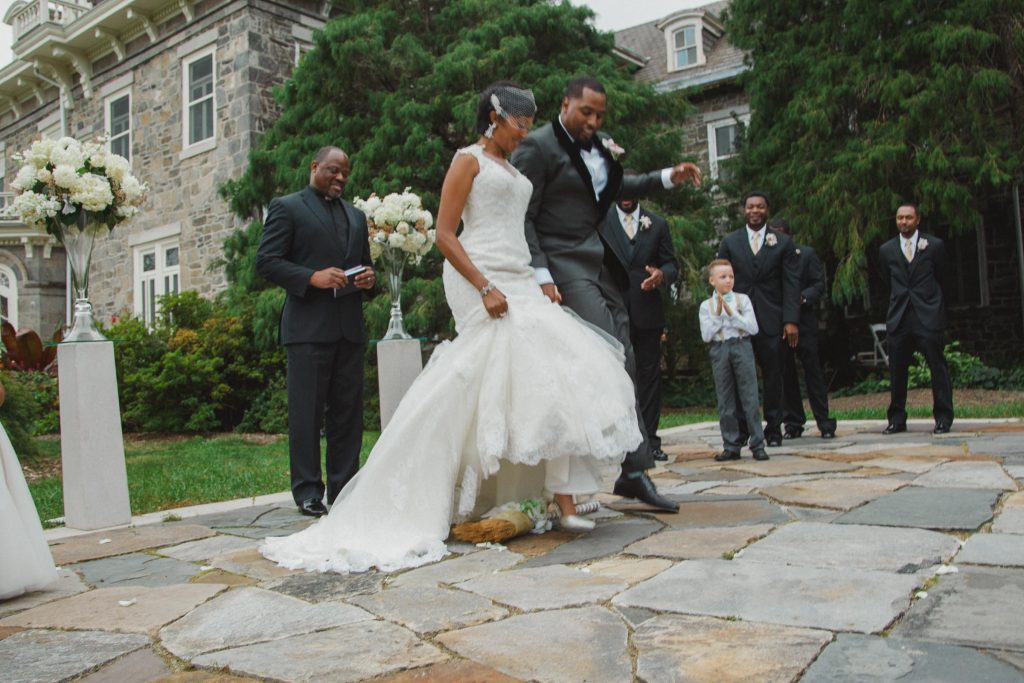 Bride and Groom Jumping the Broom at Cylburn Arboretum. Howerton+Wooten Events.