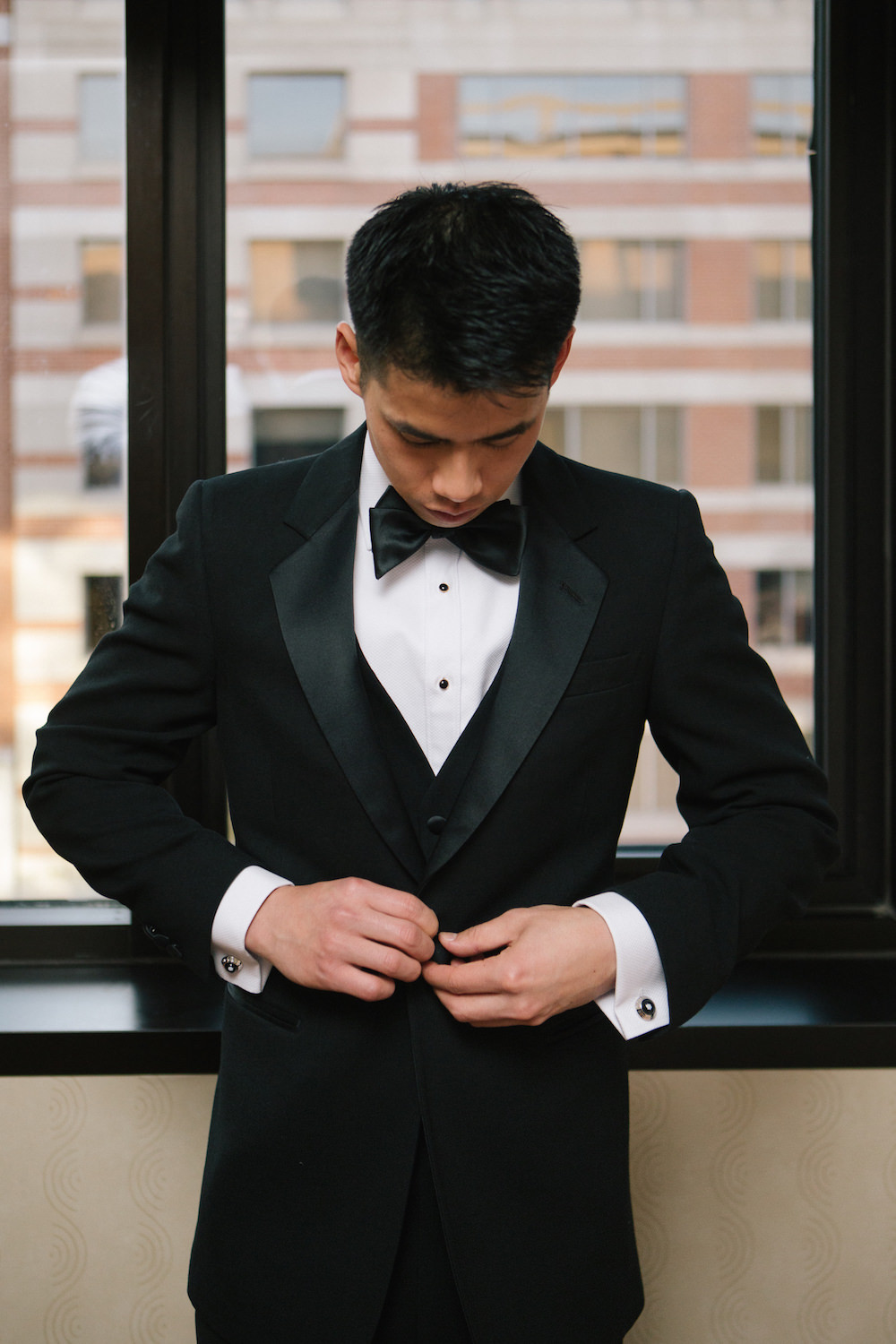 Groom Getting Dressed in His Tuxedo. Mike Sperlak Photography. Howerton+Wooten Events.